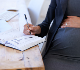 Gravid kvinna planerar för föräldraledighet. 